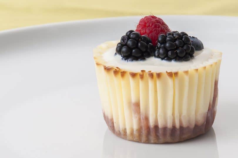 raspberry and blackberry topped dessert on white plate