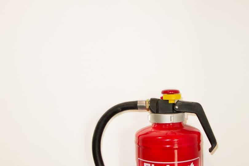 fire extinguisher against white wall