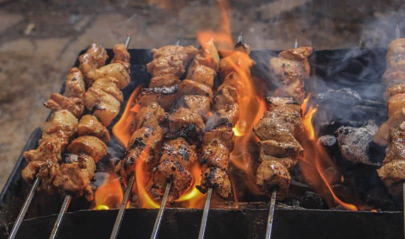 bbq skewers on open flames