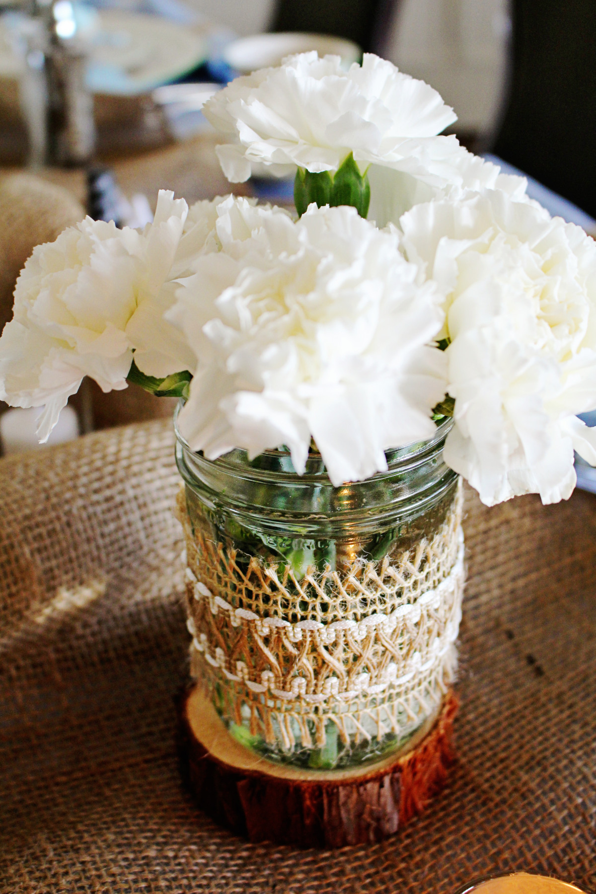 Mason jar flower vase with white blooms