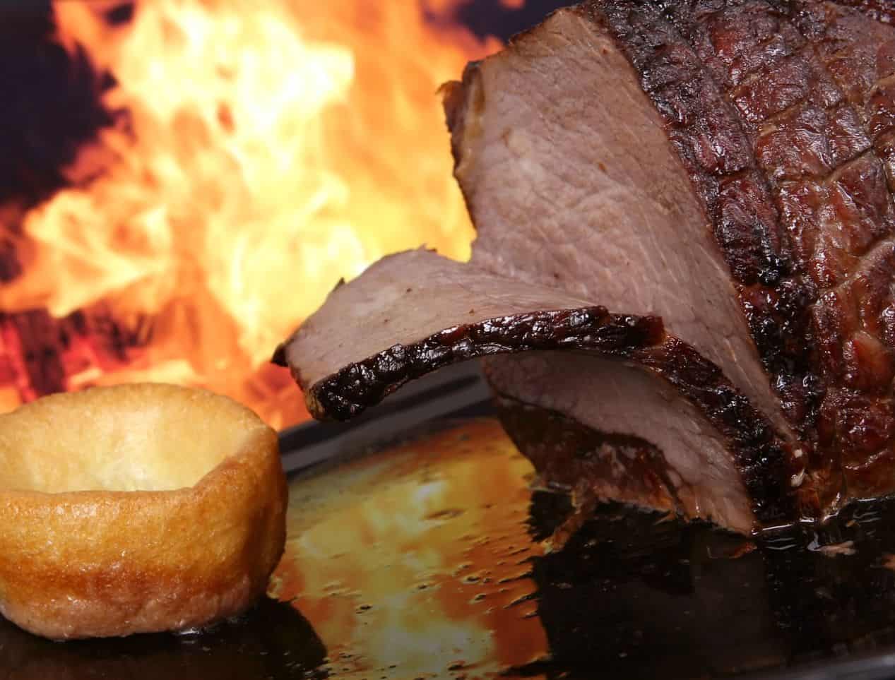 BBQ beef and Yorkshire pudding in front of open flame