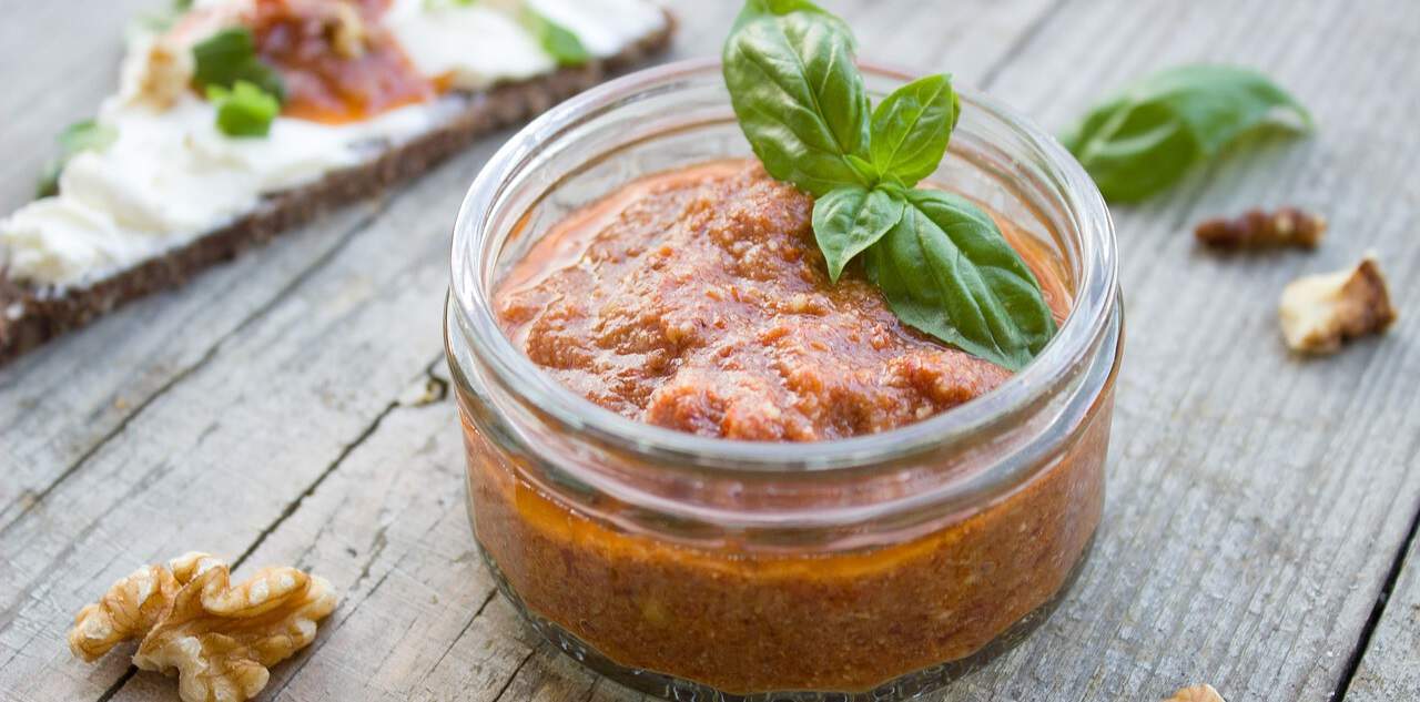 bbq relish in a glass pot on wooden surface