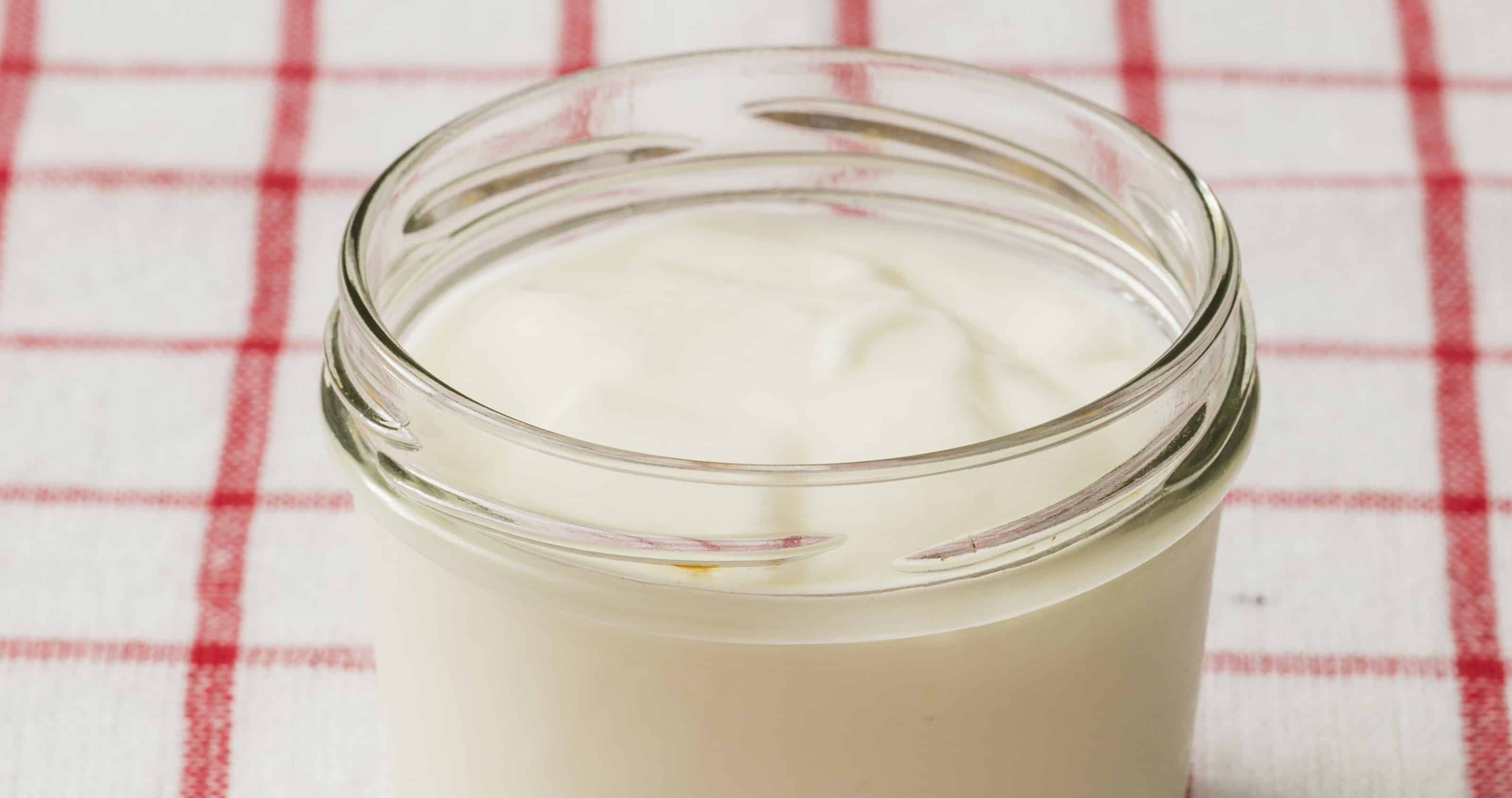 mayonnaise in glass jar on check tea towel