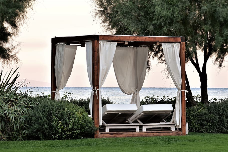 DIY garden cabana lounge with white curtains for privacy