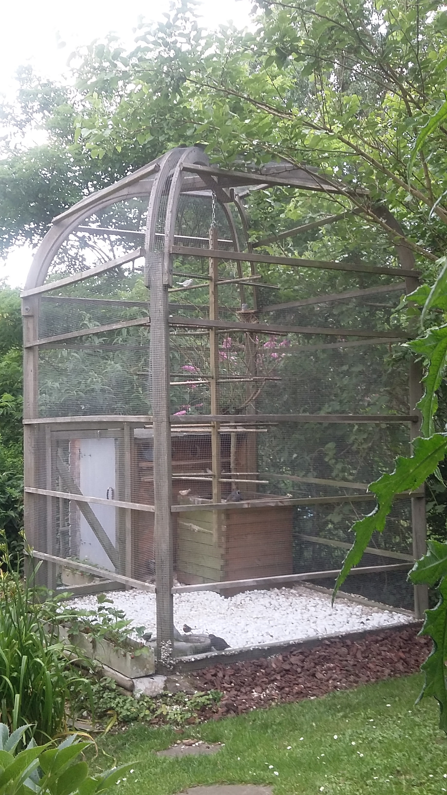 Semi dome-shaped wooden outdoor bird aviary