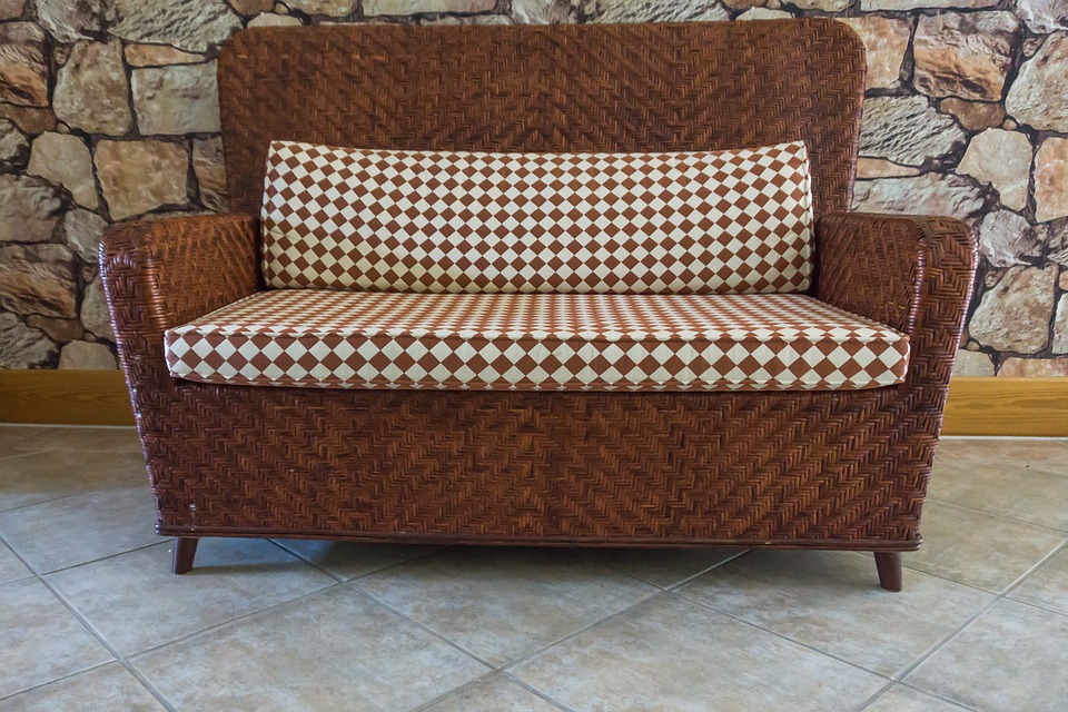 Rattan sofa with patterned print seat cushion