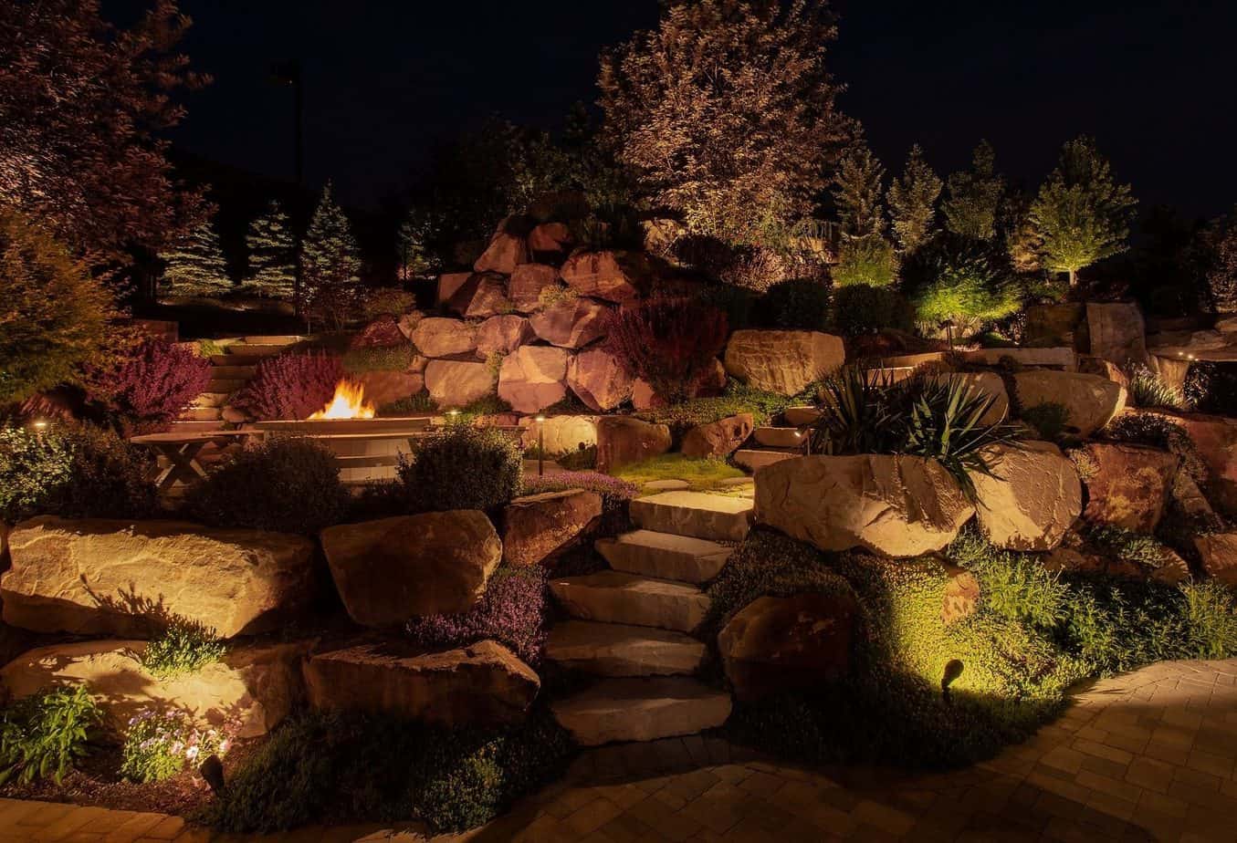 Outdoor lighting that highlights the rocks, casting ample light on the overall landscape and walkway