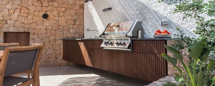 Outdoor kitchen island with a built-in BBQ gas grill