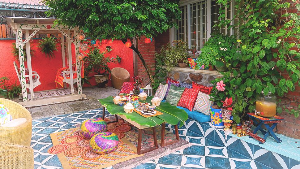 Colourful courtyard patio with bright furniture pieces
