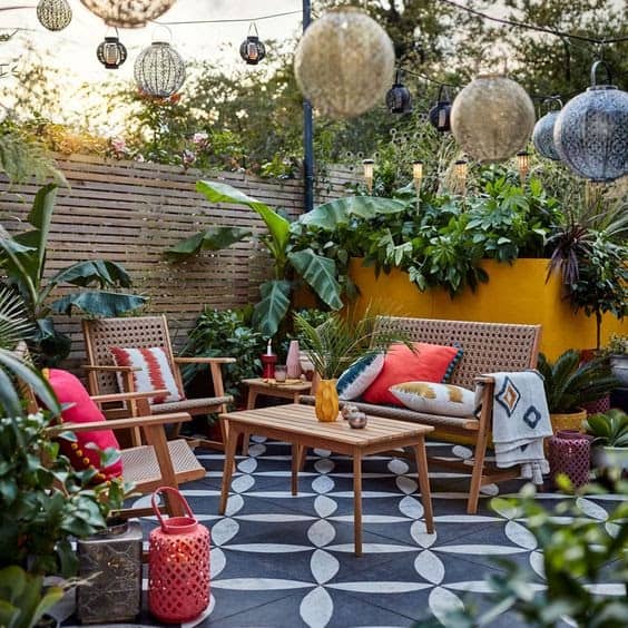 A bright wall and hanging lanterns, giving off a modern and colourful courtyard