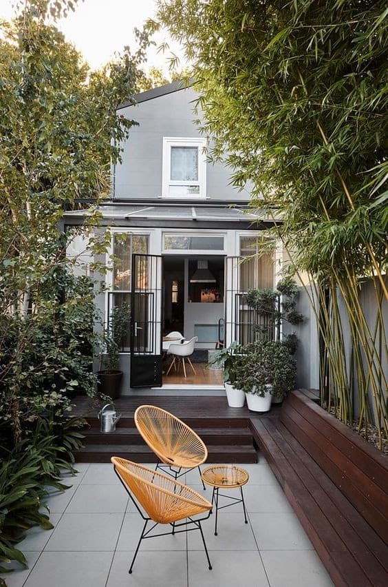 A sleek outdoor space with dark wood garden beds