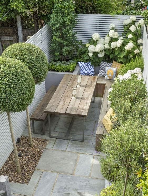 A small backyard living space with picnic table for al fresco dining