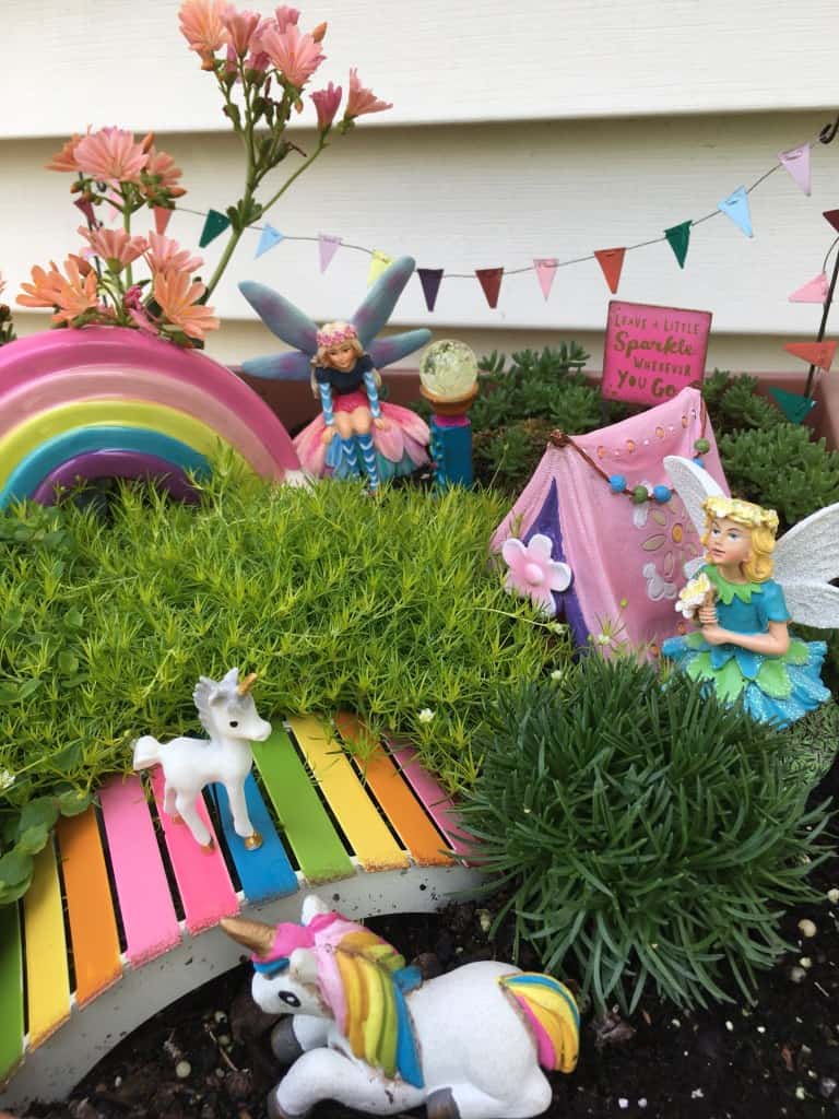 Fairy and unicorn garden with rainbow and colourful bridge