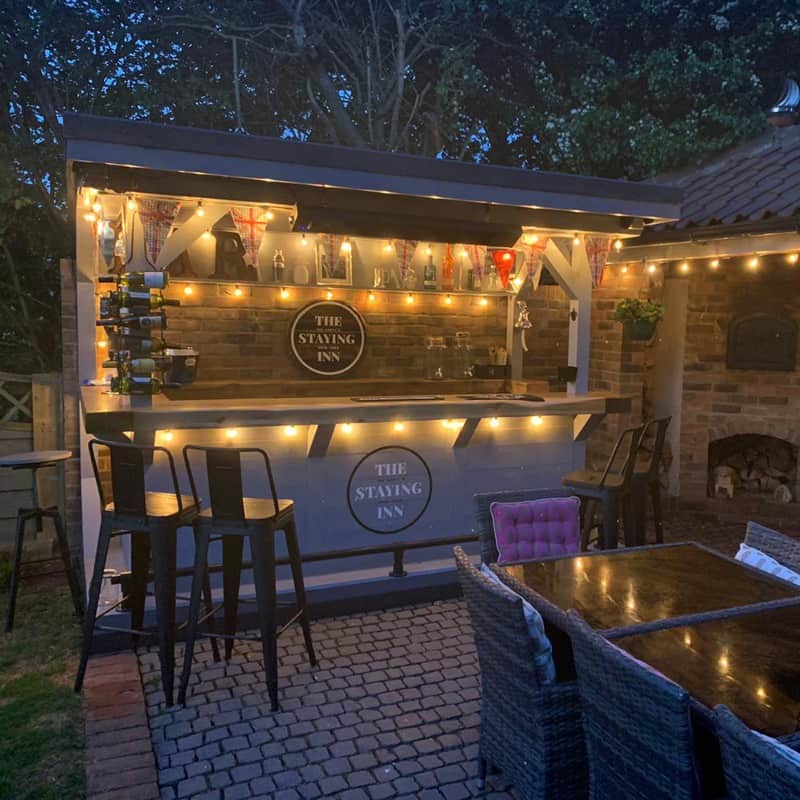 A simple outdoor pub with few bar stools and built a little bar surface for serving drinks
