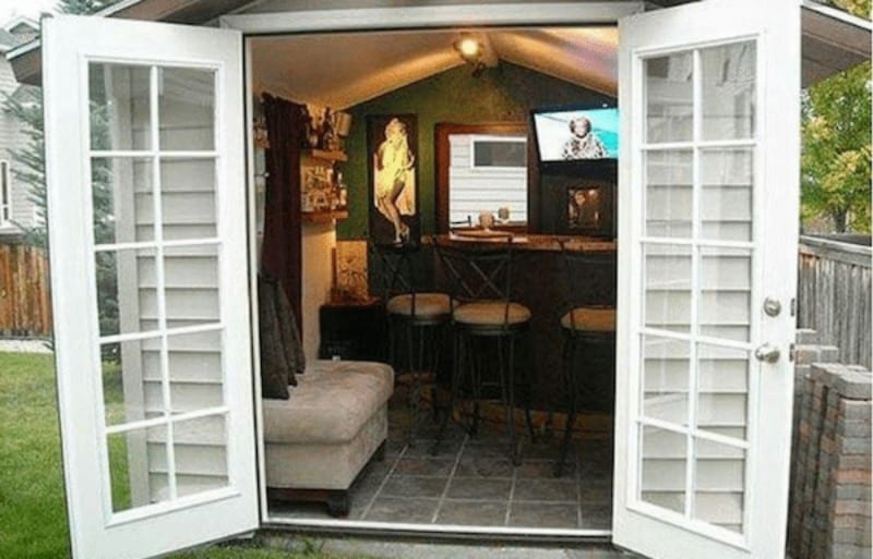 shed with open double doors and a bar and tv inside