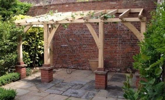 Traditional wooden pergola with brick bases