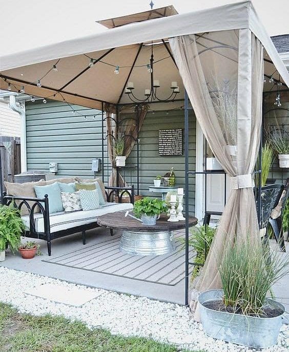 A classy metal-framed gazebo, stylish curtains and some homely touches