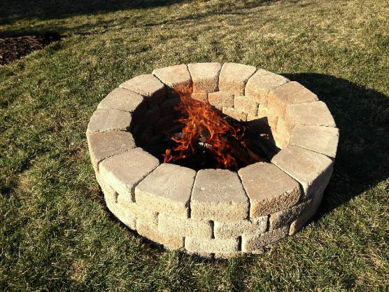 Stacked stones backyard fire pit.