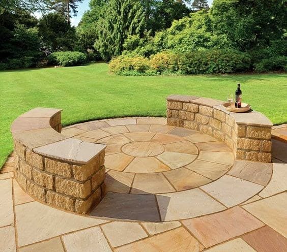 A stone/brick bench outdoors ideal for afternoon hangout or small get-togethers outdoors