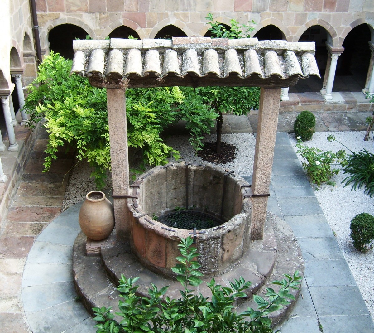 A massive wishing well positioned in the middle of a courtyard