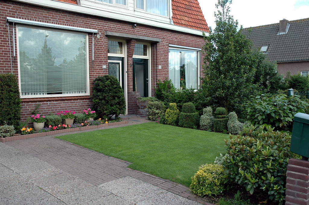 Small family garden with mixed concrete paving and lawn