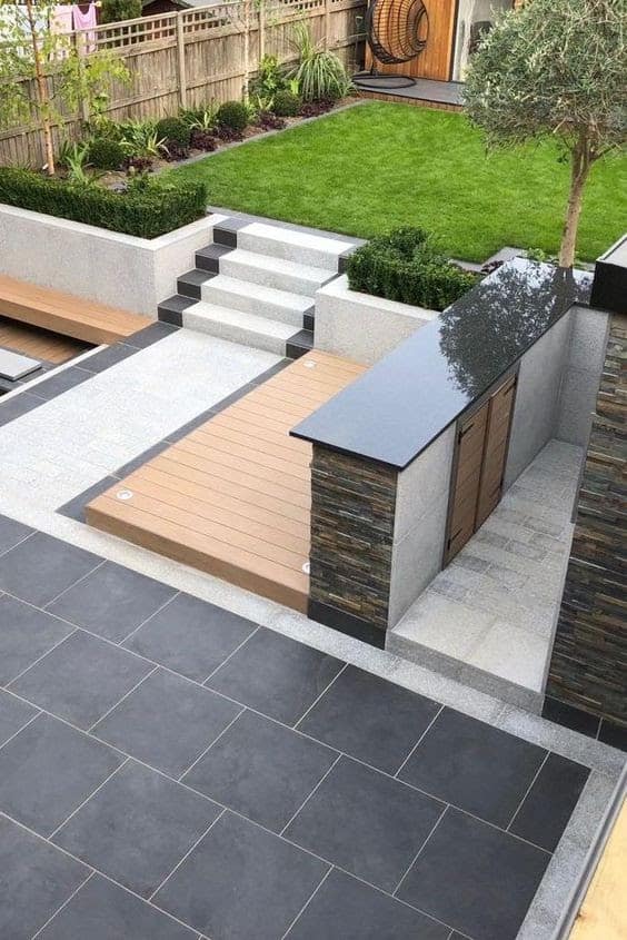 Wood mixed with black and white porcelain, giving off a luxurious outdoor patio