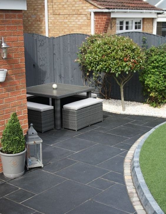 Contemporary style backyard with garden furniture and Indian sandstone in grey 