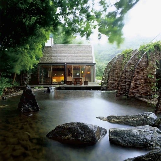 Zen-like garden house with a pool-sized water pond paired with big natural stones