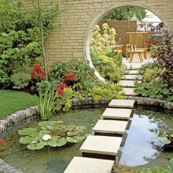 A mirror as a reflective source, adding extra space and light to the pond and overall garden