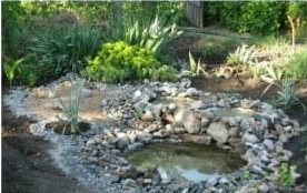 Recycled tractor tire pond with a stream