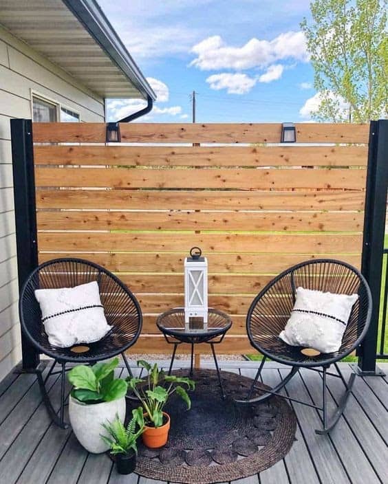 Small fence providing privacy to an outdoor seating area
