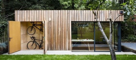 Minimalist and moden-looking garden office with hanging bikes as decors