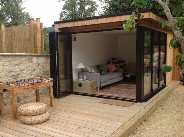 A wooden garden room with wooden deck