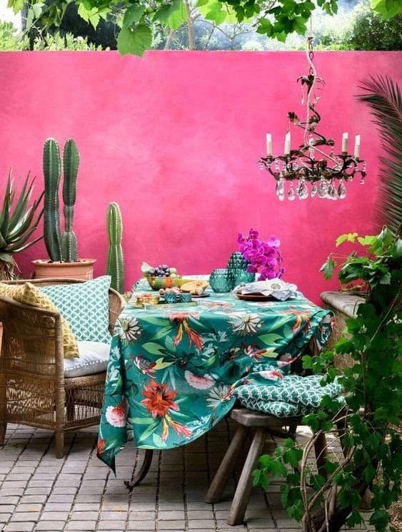 A cosy yet elegant patio set-up with colourful and bright background and accessories