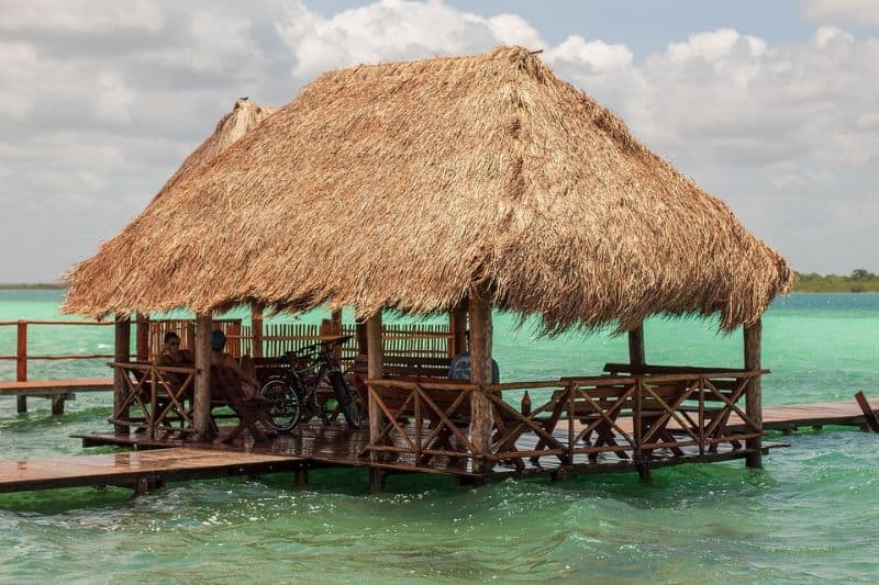 Palapa straw-roof hut on a jetty on the water