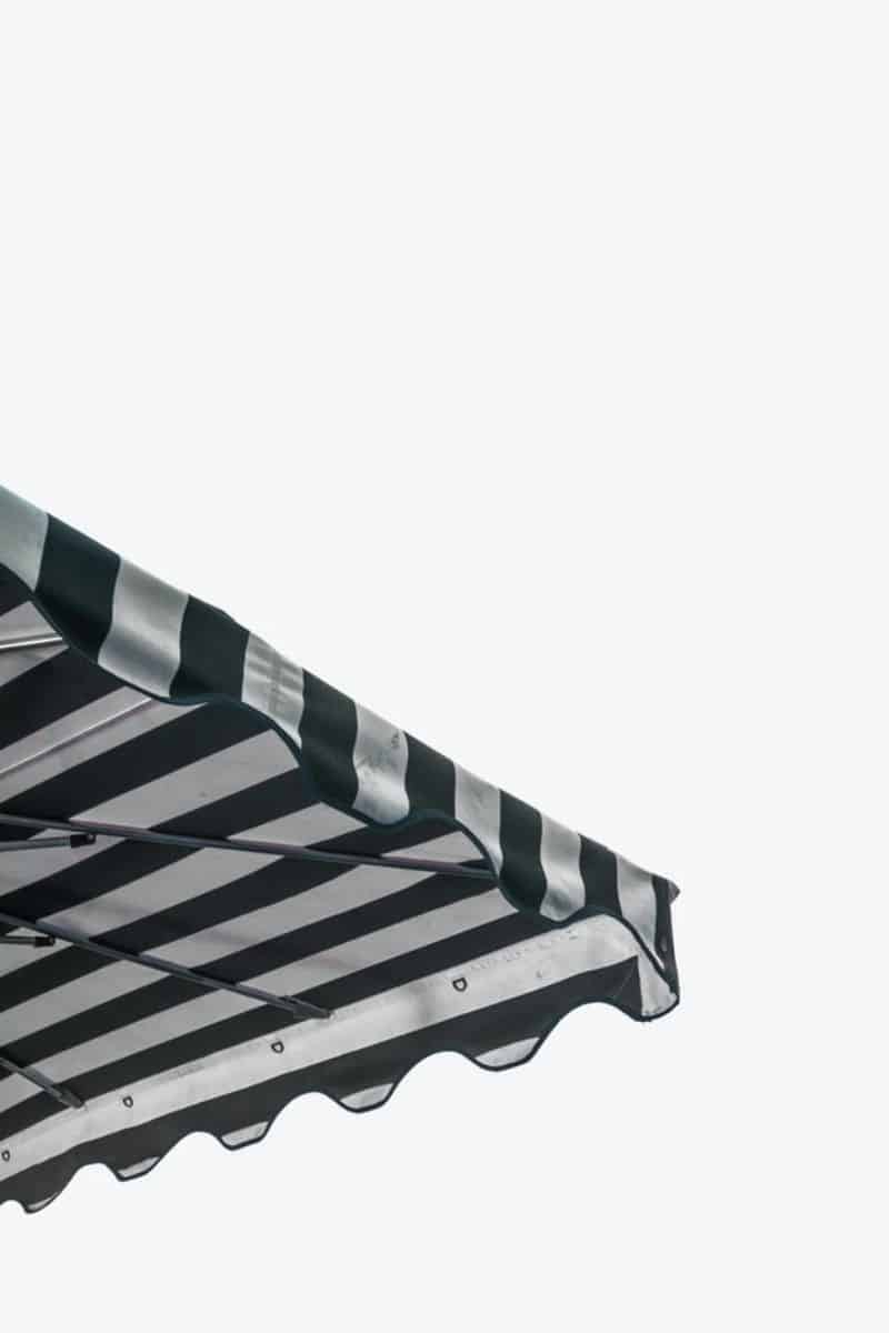 black and white striped edge of a gazebo against a grey sky