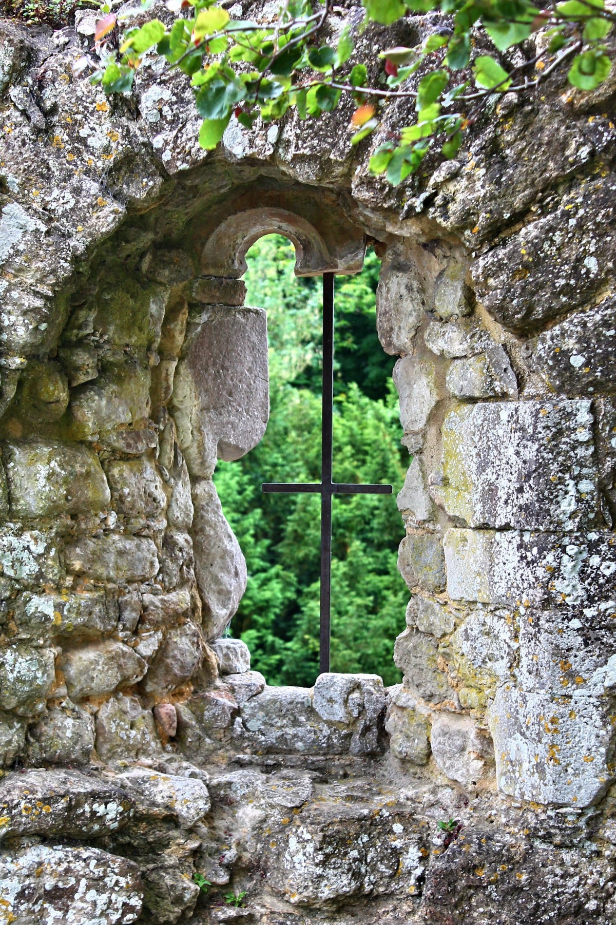 Stone garden wall with a whimsical hole that acts as a window