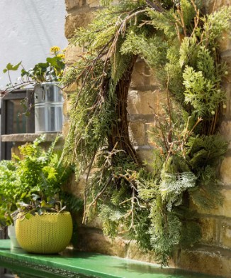 A garden wall decorated with giant outdoor wreath