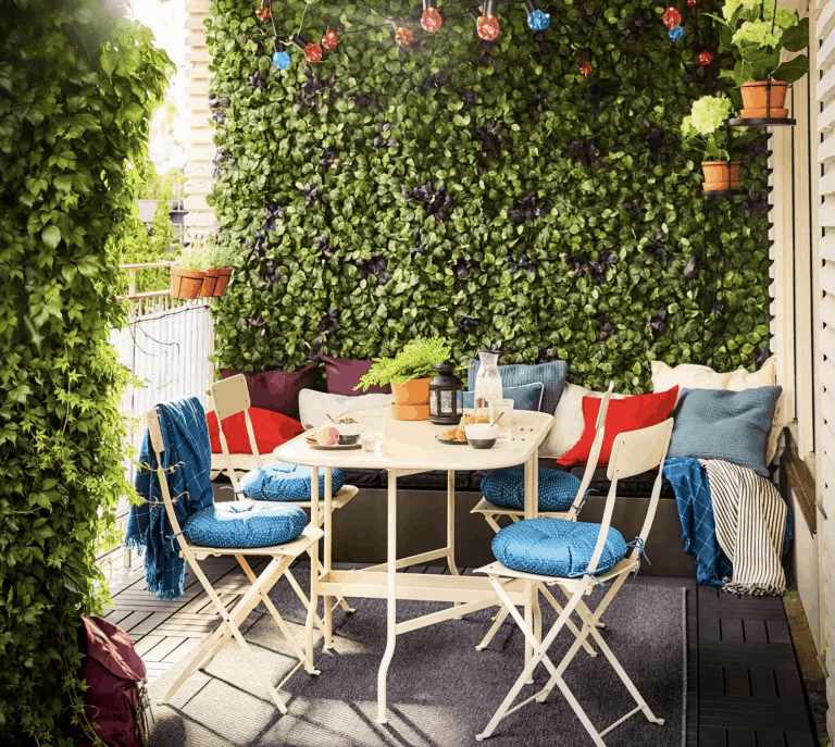 artificial plant panels with outdoor seating and cushions