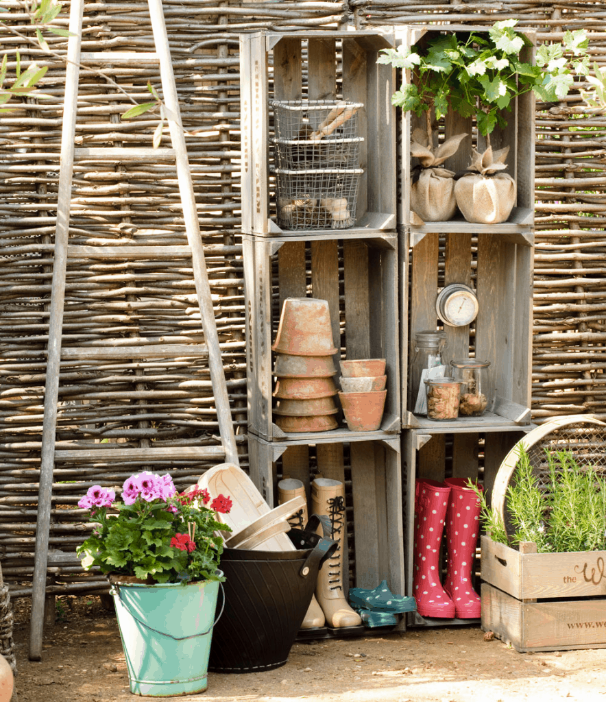 woven willow twigs with planters and wellingtons on shelving