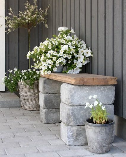 simple stacked stone bench with flowers