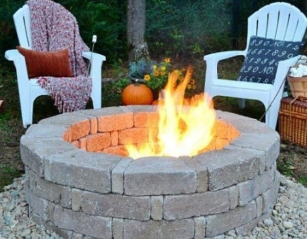 round stone fire pit with chairs