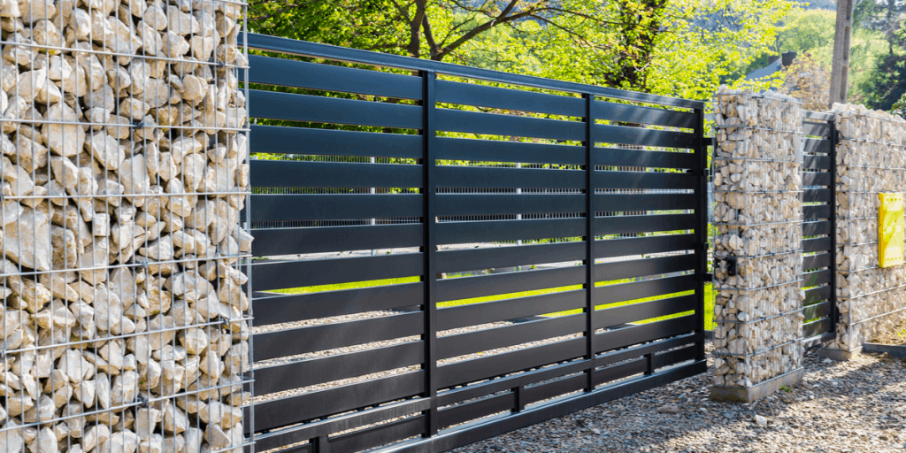 black horizontal slat gate between gabion walls