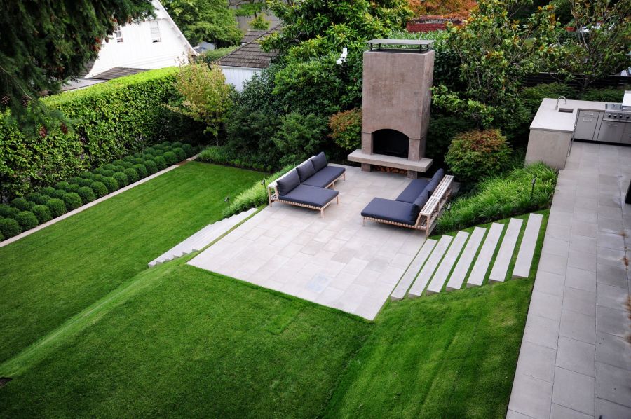 Sloped garden with multi-levelled area for entertainment and relaxation