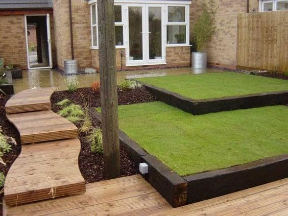 Another modern looking garden with artificial grass and railway sleepers