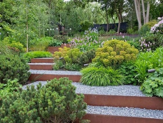 steep sloped garden by adding stairs and tiered planters, giving off a simple-look garden