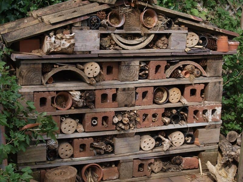 bug hotel with apex roof and brick sections