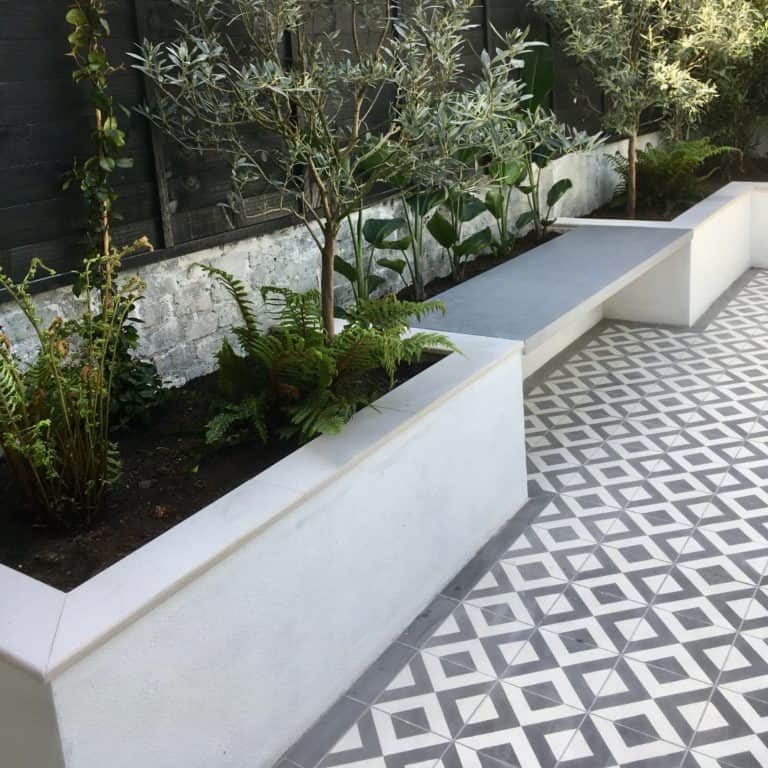 Simple, white raised beds with patterned tiles