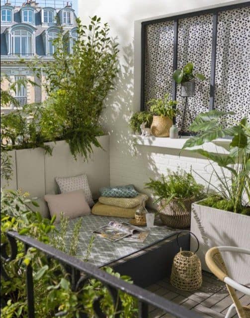 A modern, comfy seating spot, surrounded by plants