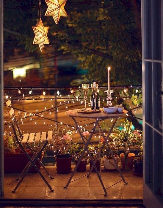 The city of love inspired balcony with fairy lights and a lit candle